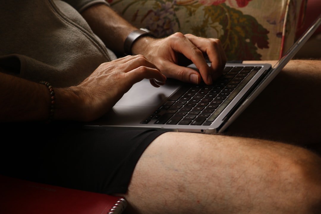 person typing laptop home office