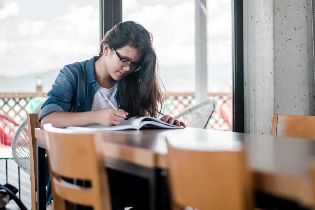 person studying textbook with coffee
