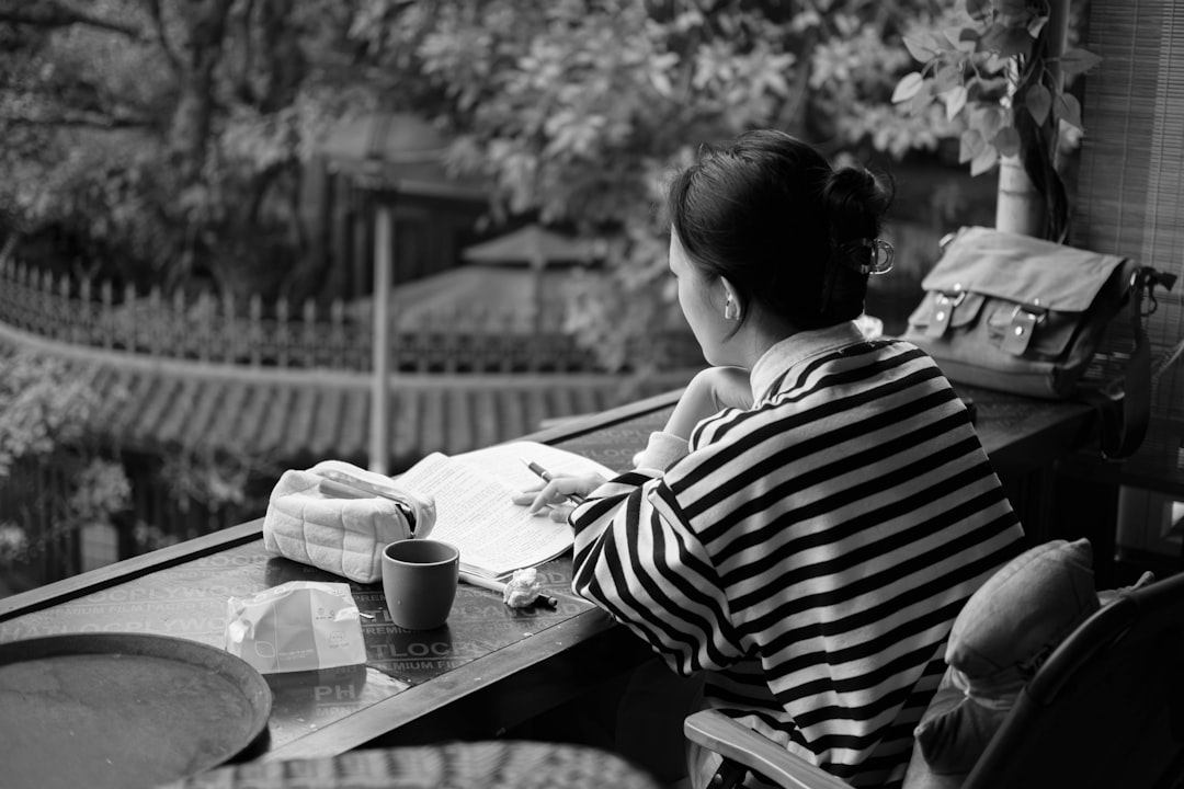 japanese man planning notebook coffee night