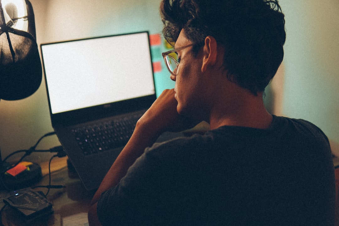 developer studying laptop night home office