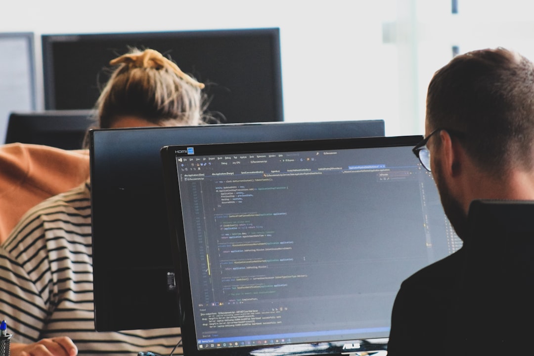 engineer reviewing code on monitor