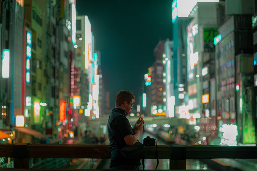 japanese businessman checking smartphone at night
