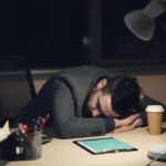 exhausted game developer late night office