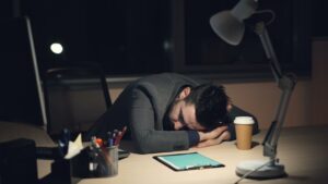 exhausted game developer late night office