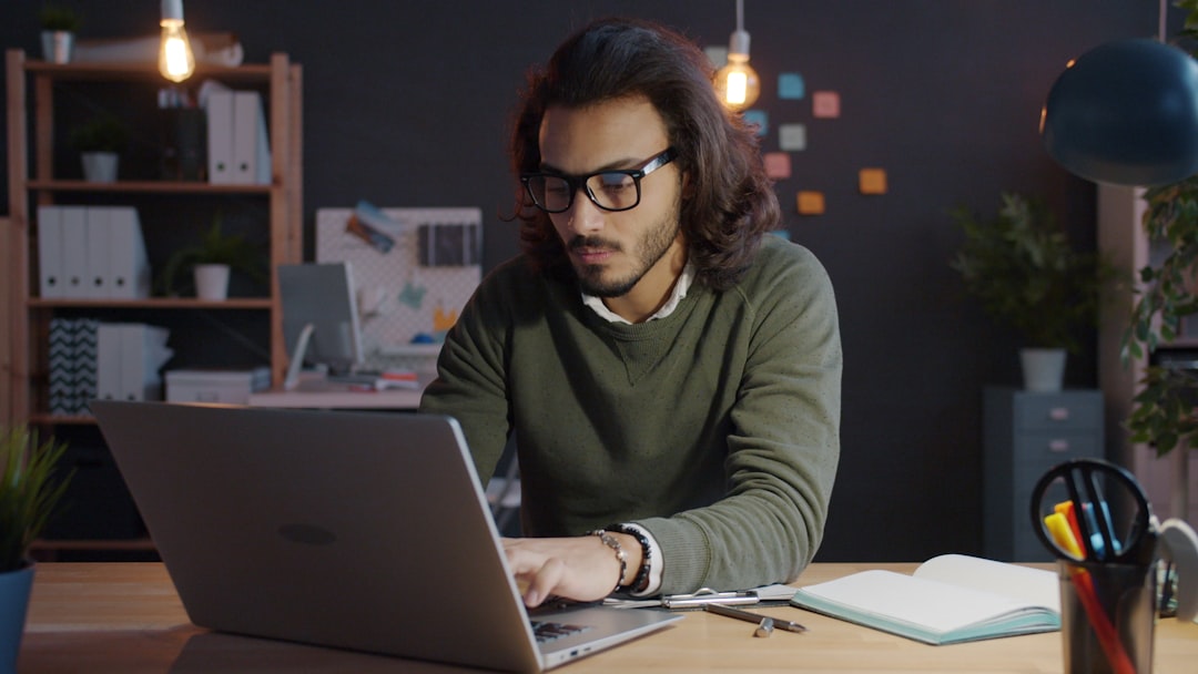 businessman looking at laptop late night