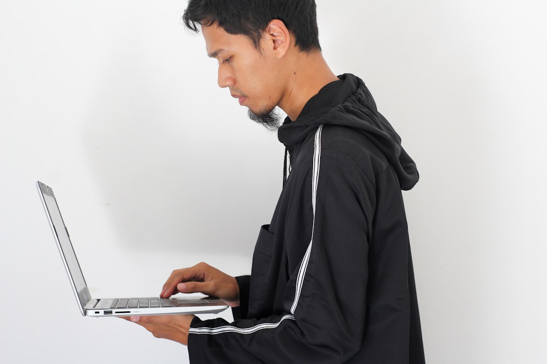 young man job hunting laptop
