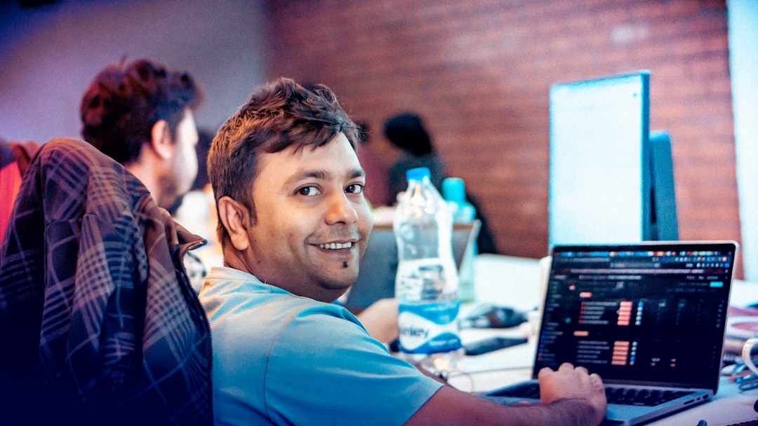 happy software engineer working laptop