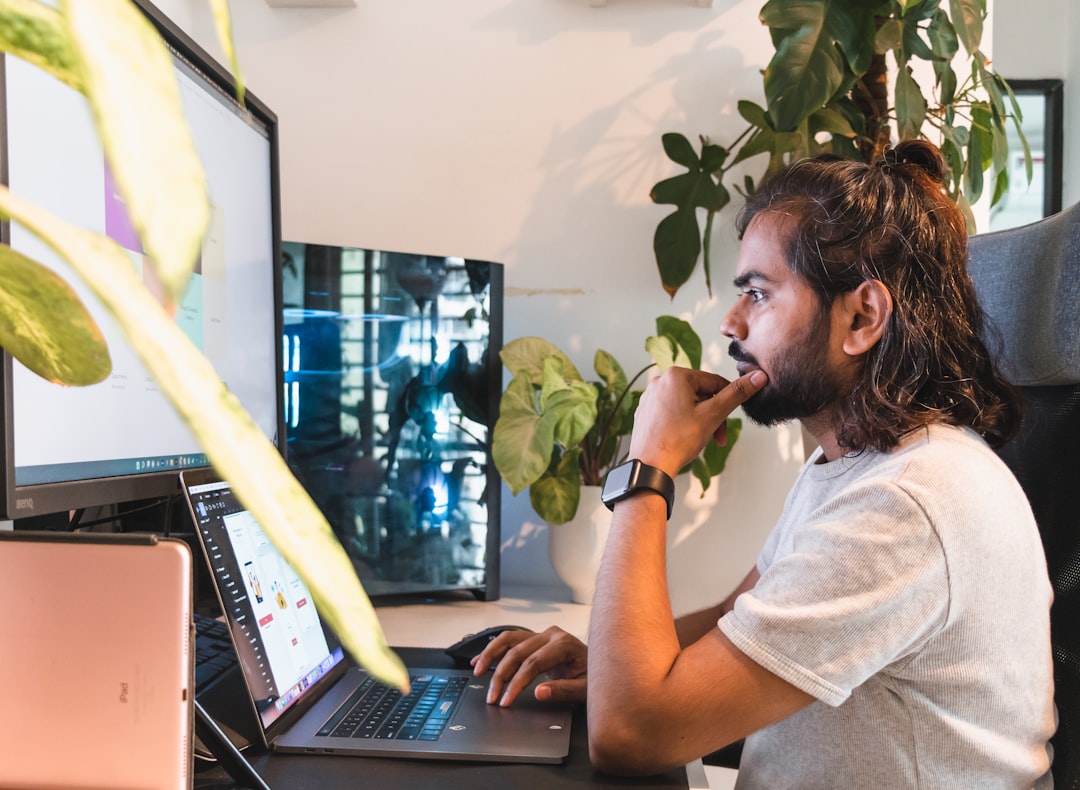 focused man working laptop home office