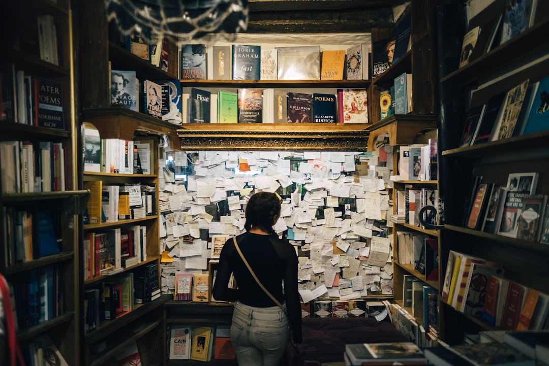 person choosing book bookstore shelf decision