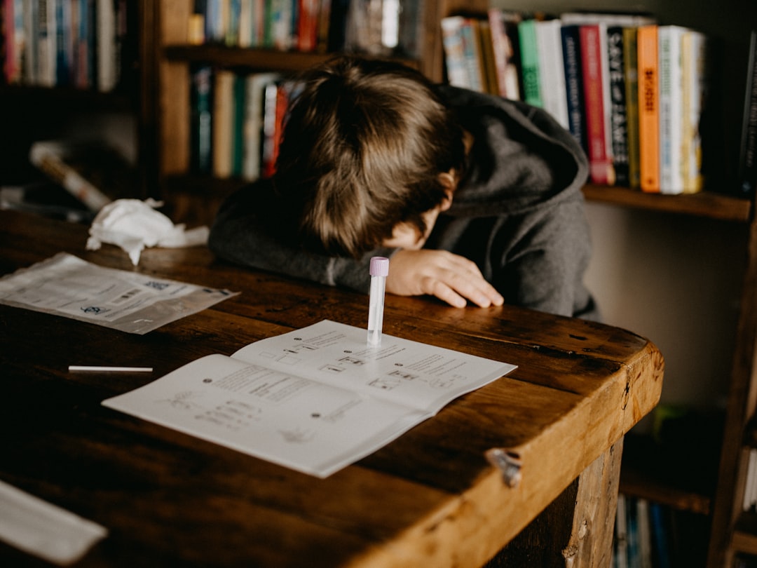 scattered books desk frustrated person