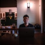 japanese man working laptop home night