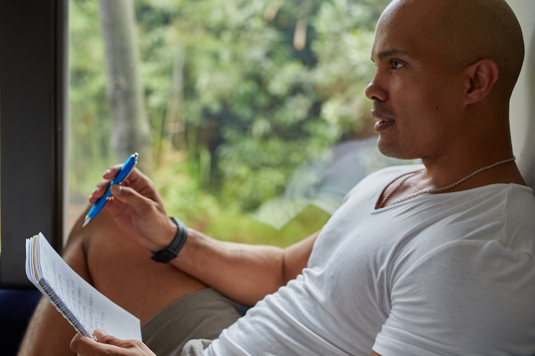 man writing self reflection questions