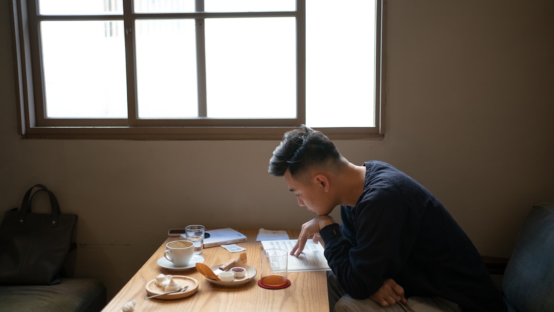 japanese man writing plan notebook coffee