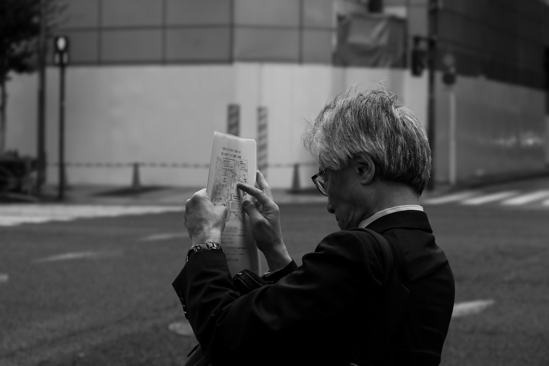 frustrated japanese businessman looking at offer letter