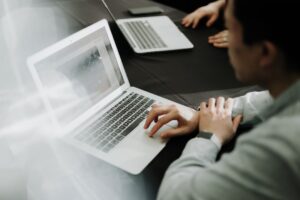 business person comparing online courses laptop