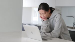 japanese man worried laptop home