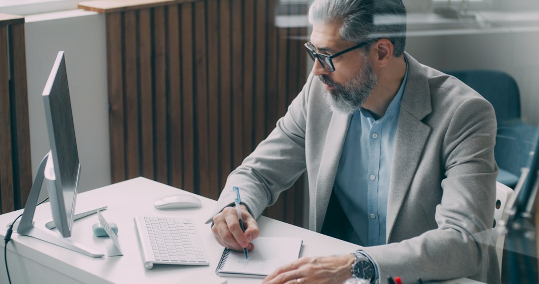 businessman writing notebook office desk