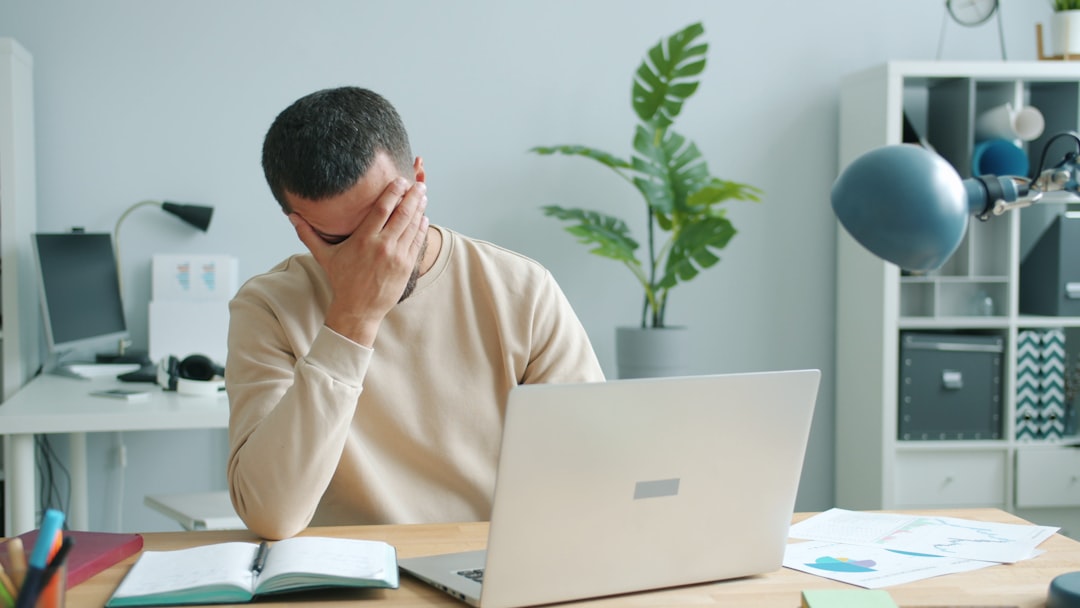 japanese man frustrated with notebook