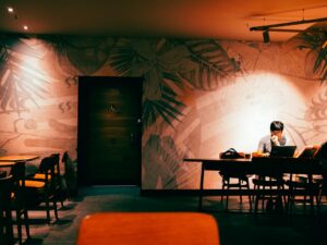 japanese woman studying laptop night cafe