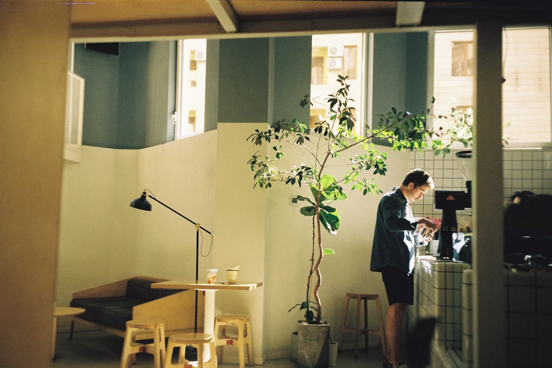 young japanese businessman reading book cafe morning