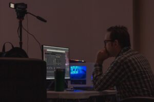 tired man laptop editing video late night
