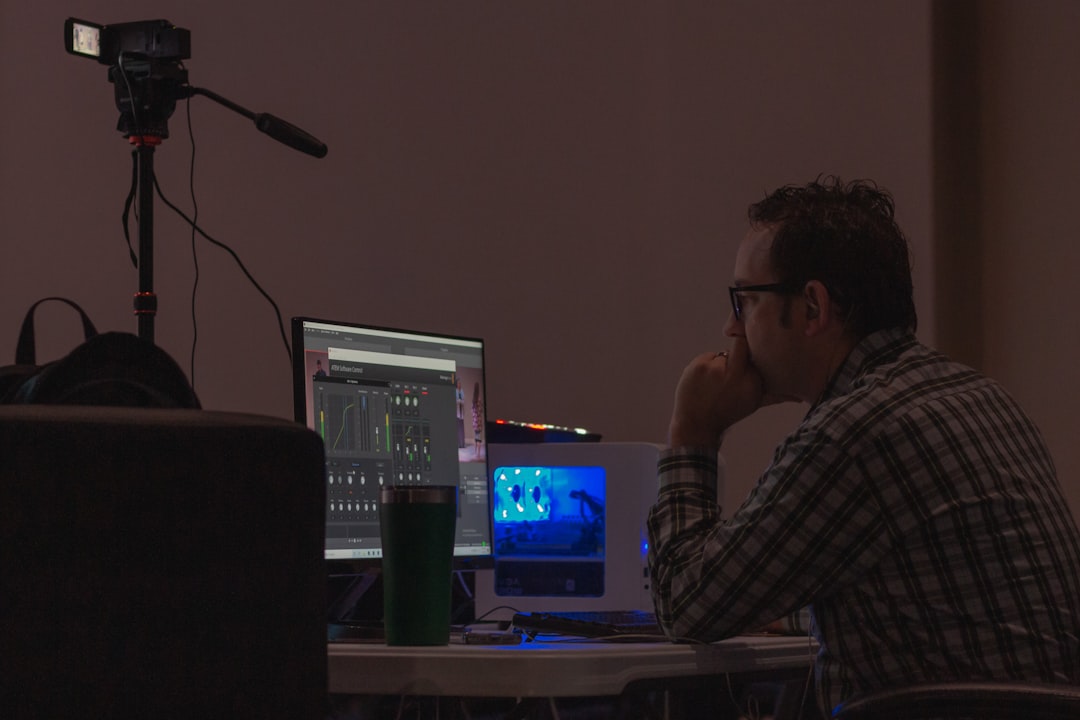 tired man laptop editing video late night
