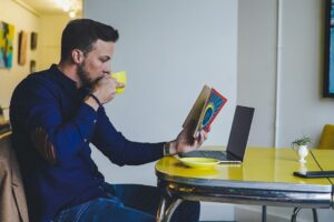 businessman reading career book cafe morning