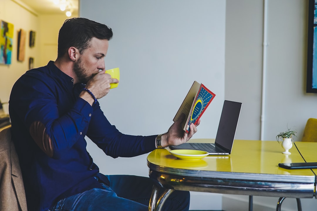 businessman reading career book cafe morning