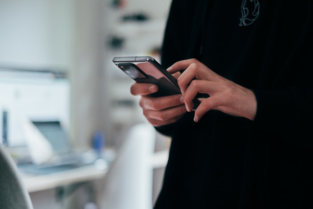 person reading reviews smartphone