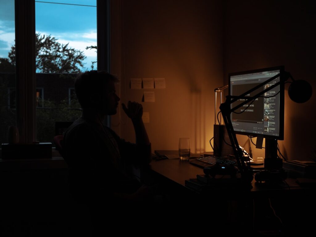 japanese businessman editing video laptop night home office
