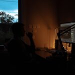 japanese businessman editing video laptop night home office