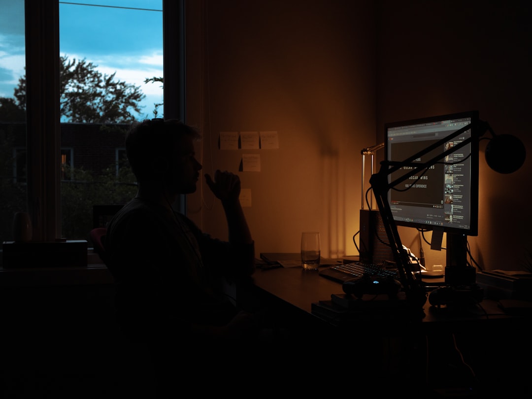 japanese businessman editing video laptop night home office