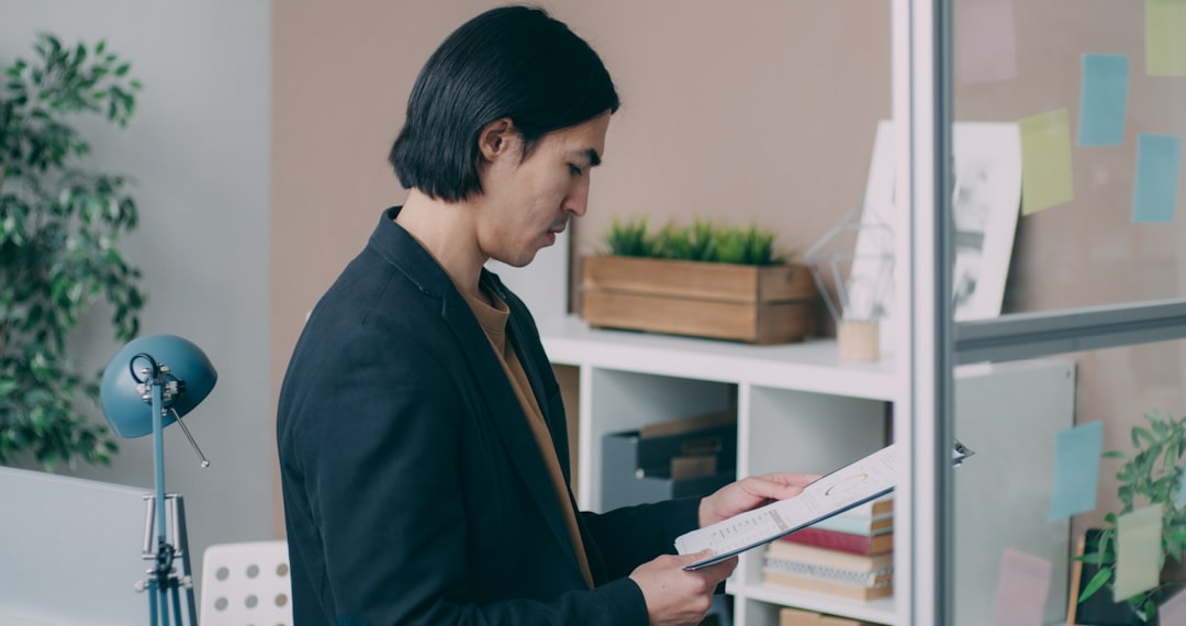japanese businessman studying licensed professional books desk
