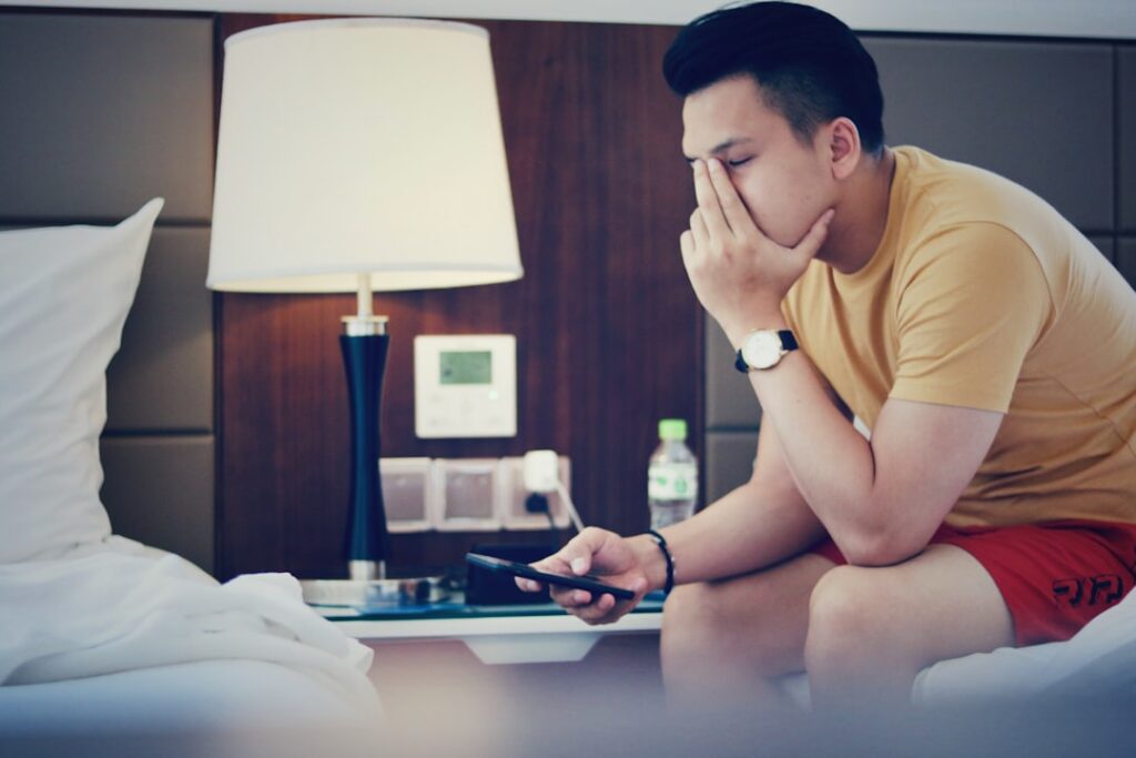 man thinking late night smartphone worried