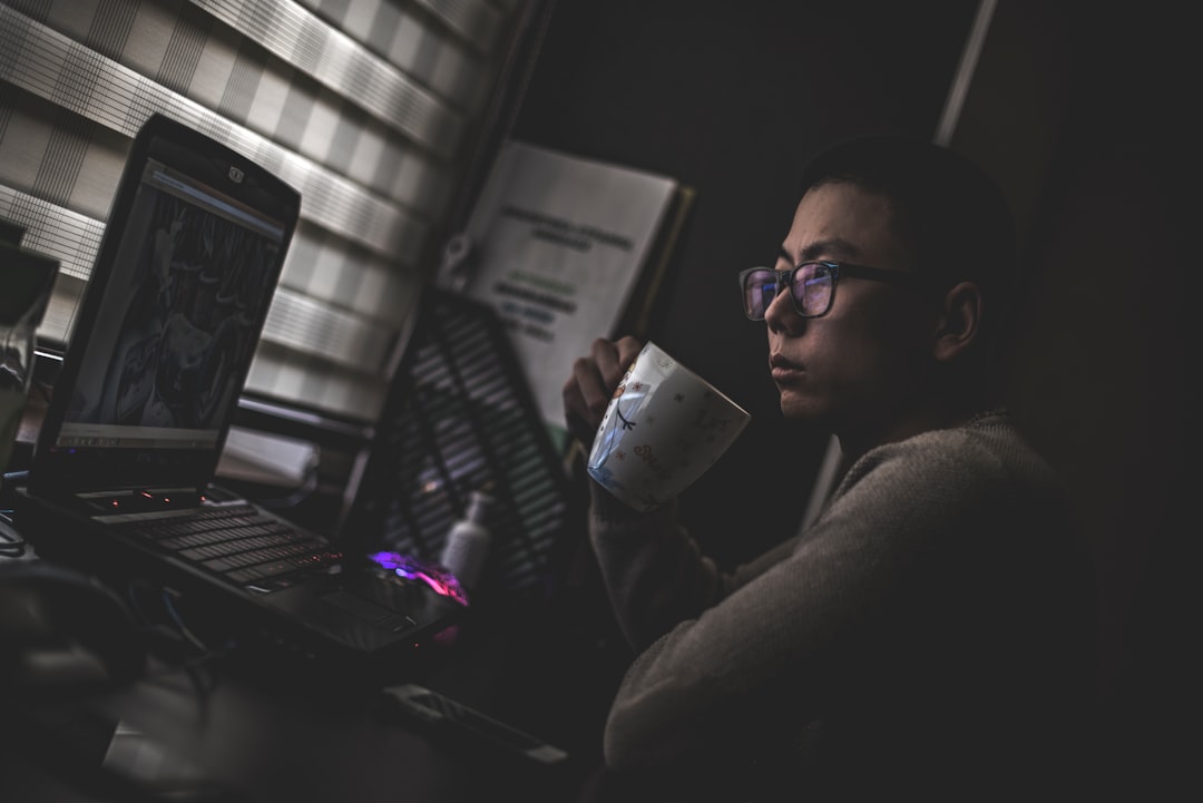 person studying laptop late at night at home