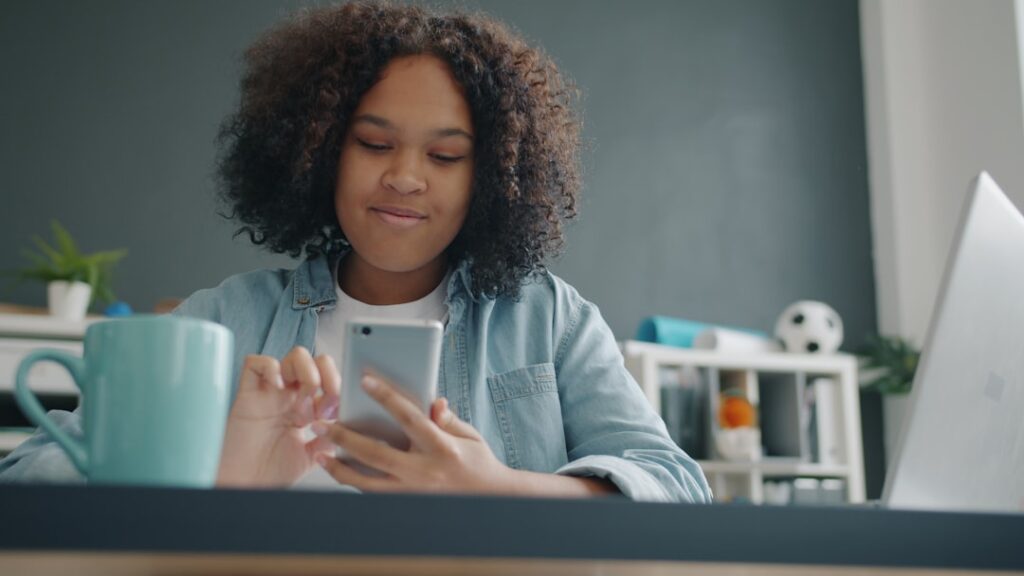 woman using smartphone social media at home desk