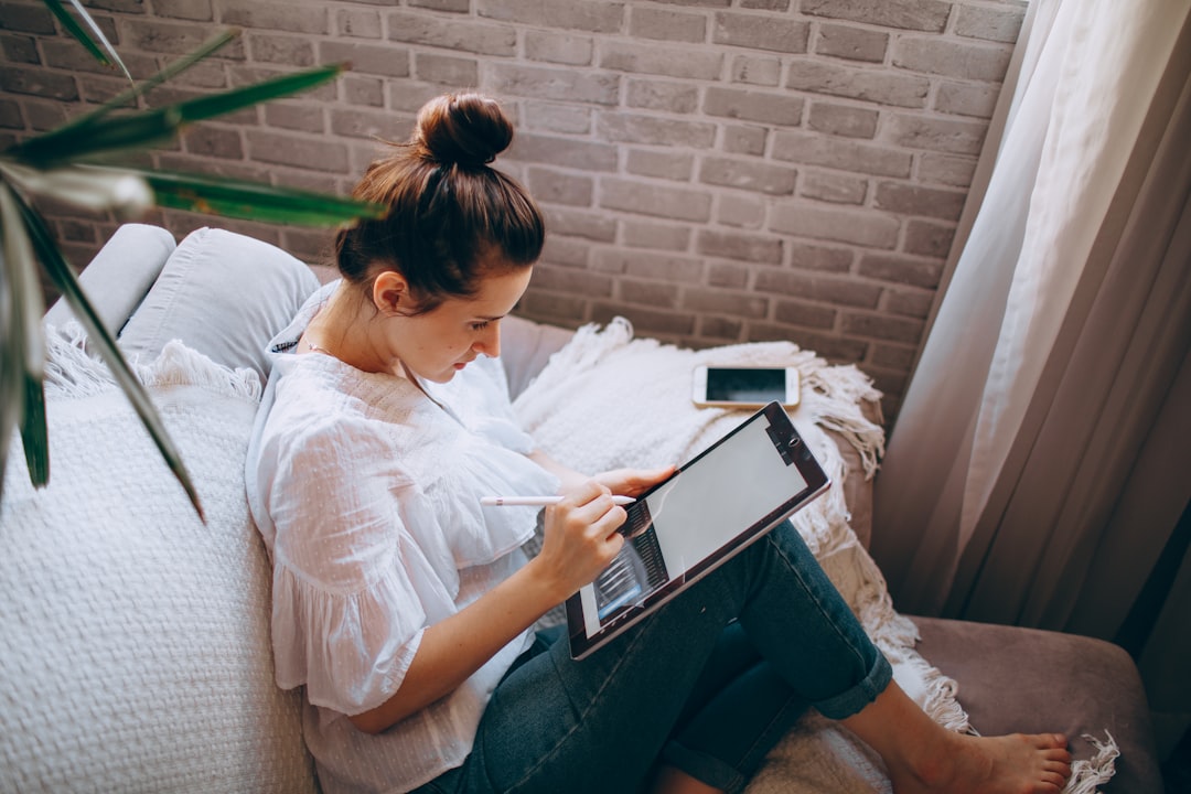 woman working on tablet illustration design at home