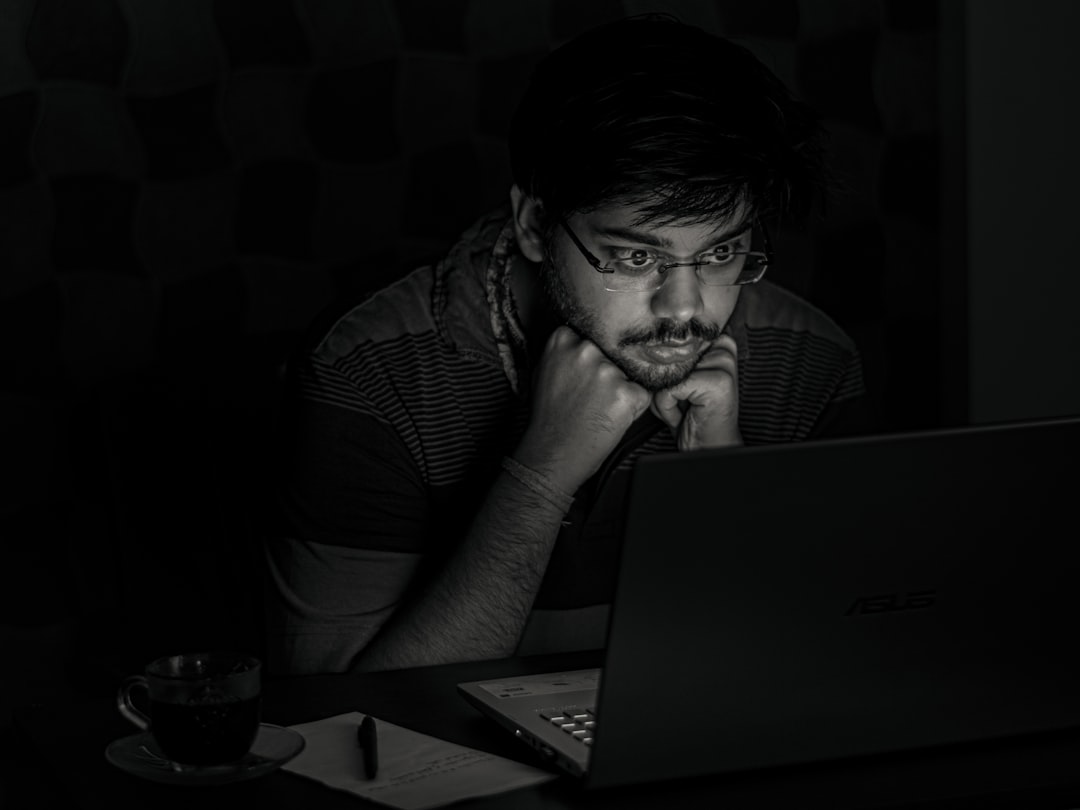 worried businessman looking at laptop at night