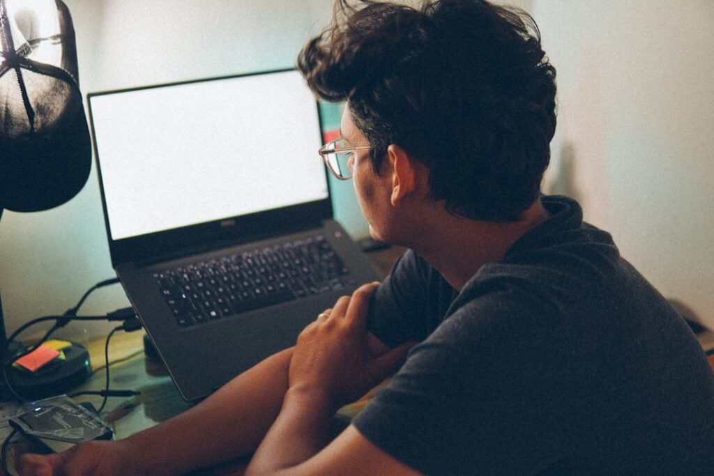 man working laptop home office night
