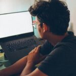 man working laptop home office night