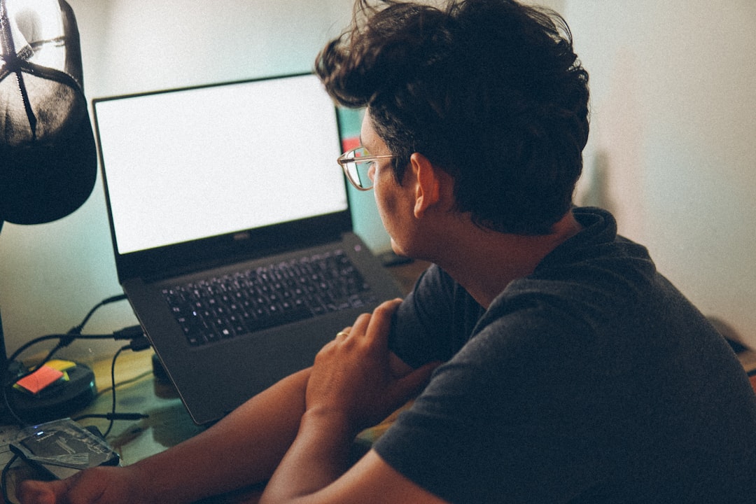 man working laptop home office night