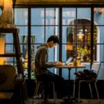 japanese man laptop cafe evening study