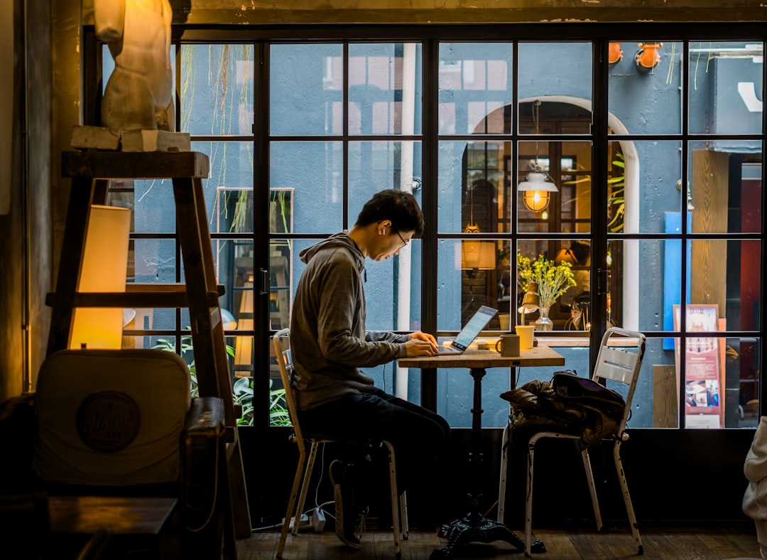 japanese man laptop cafe evening study