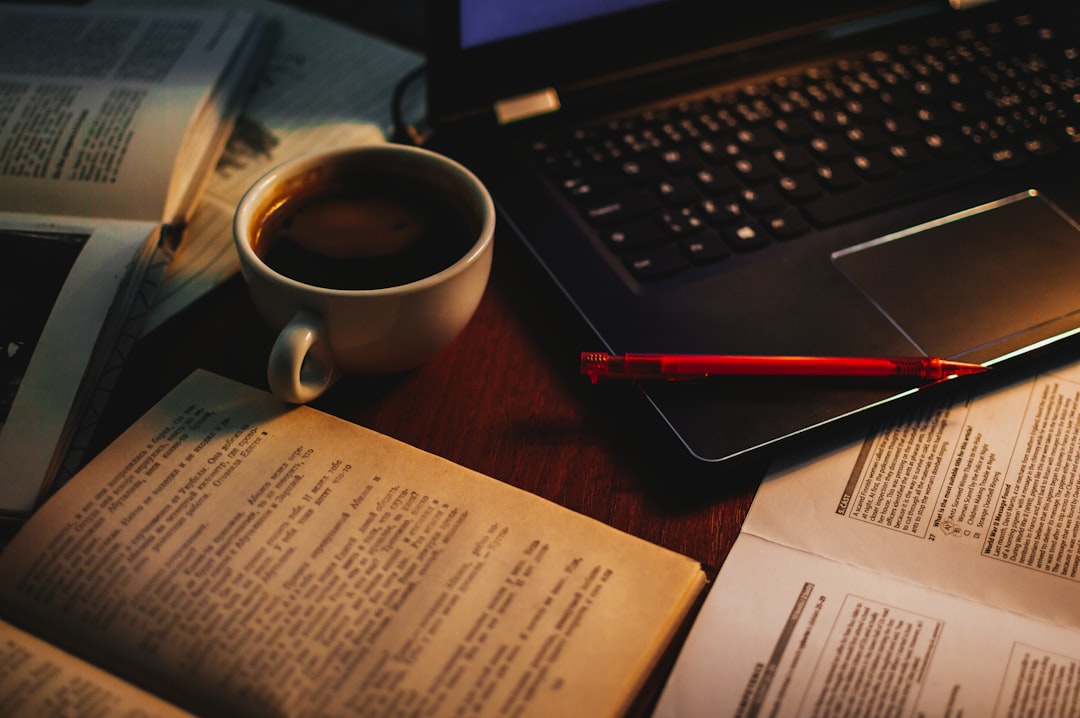 textbook and laptop side by side study