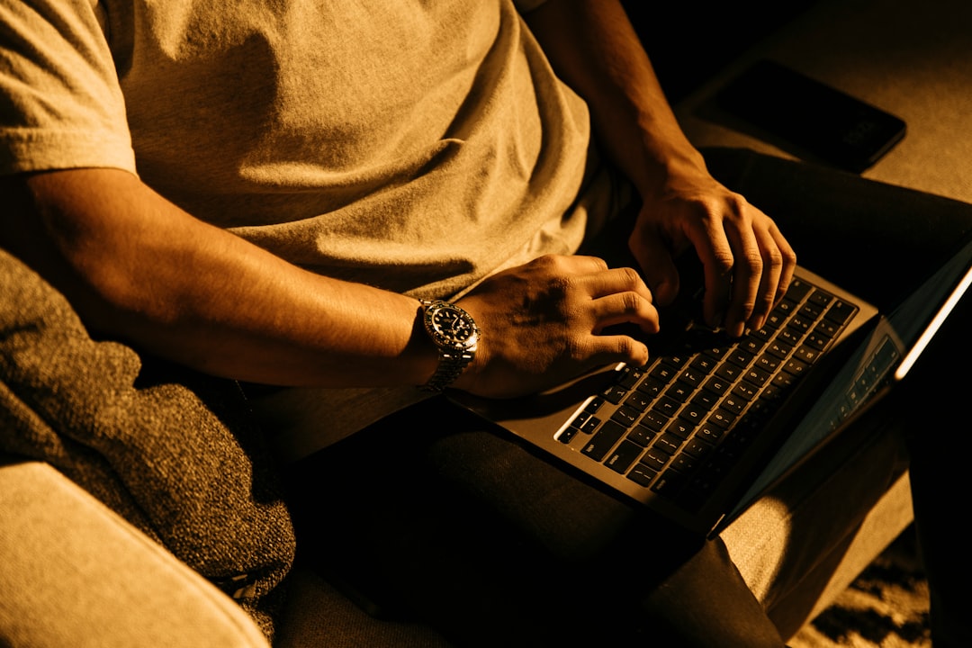 man preparing resume laptop desk night
