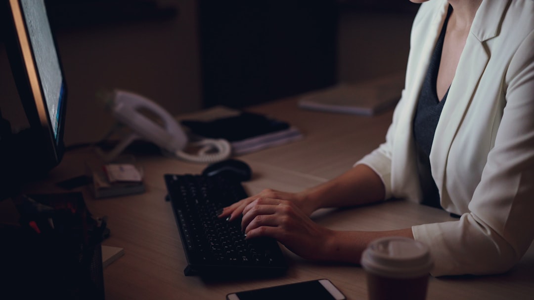 woman writing laptop home night desk