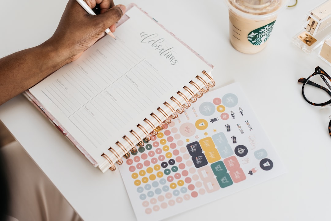 person balancing work schedule on calendar planner