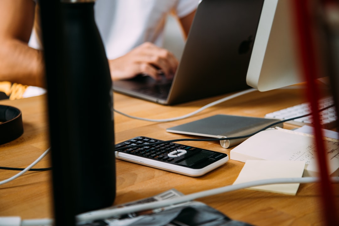 calculating income with laptop and calculator