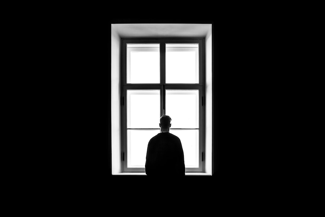 man reflecting career growth window light