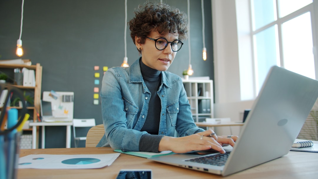 person writing with ai assistant laptop future